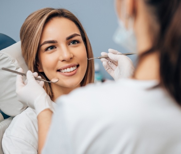 Woman smiling during periodontal exam