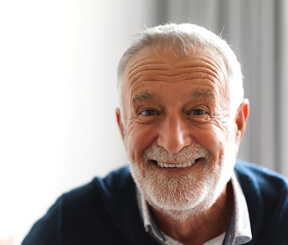 Senior man in blue shirt smiling