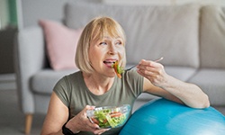 older woman eating a salad