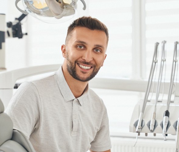 Male dental patient smiling with dental implants in Dallas, TX