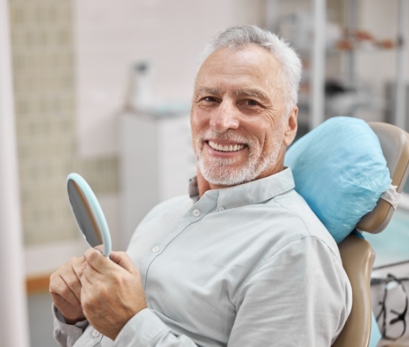 Man smiling during minimally invasive periodontal therapy consultation