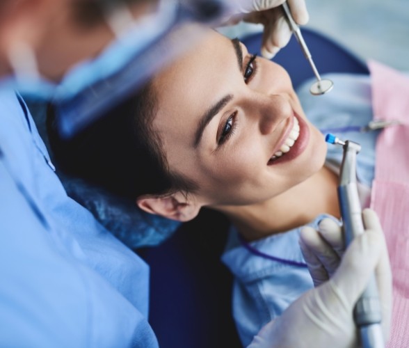 Patient smiling during periodontal cleaning