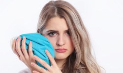 woman holding ice pack to jaw 