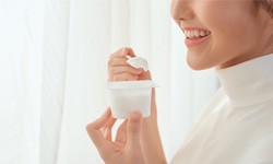 woman eating plain yogurt 