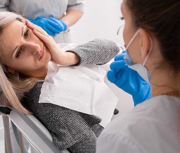 Woman with a toothache at the dentist