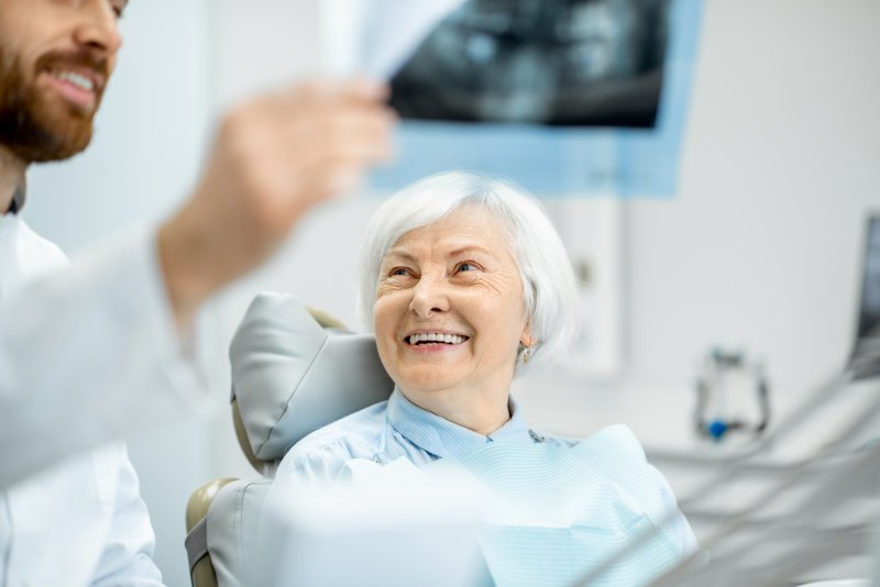 Senior woman talking to her dentist