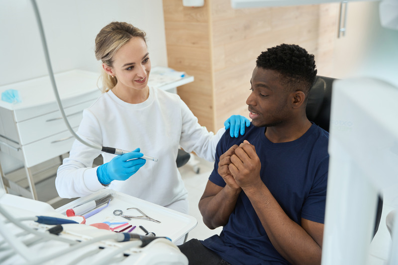 Dentist reassuring patient with dental anxiety